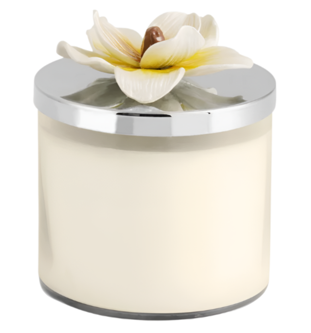 The Michael Aram Magnolia Candle features soothing white magnolia fragrance in a glass jar with a silver lid and a decorative ceramic flower.