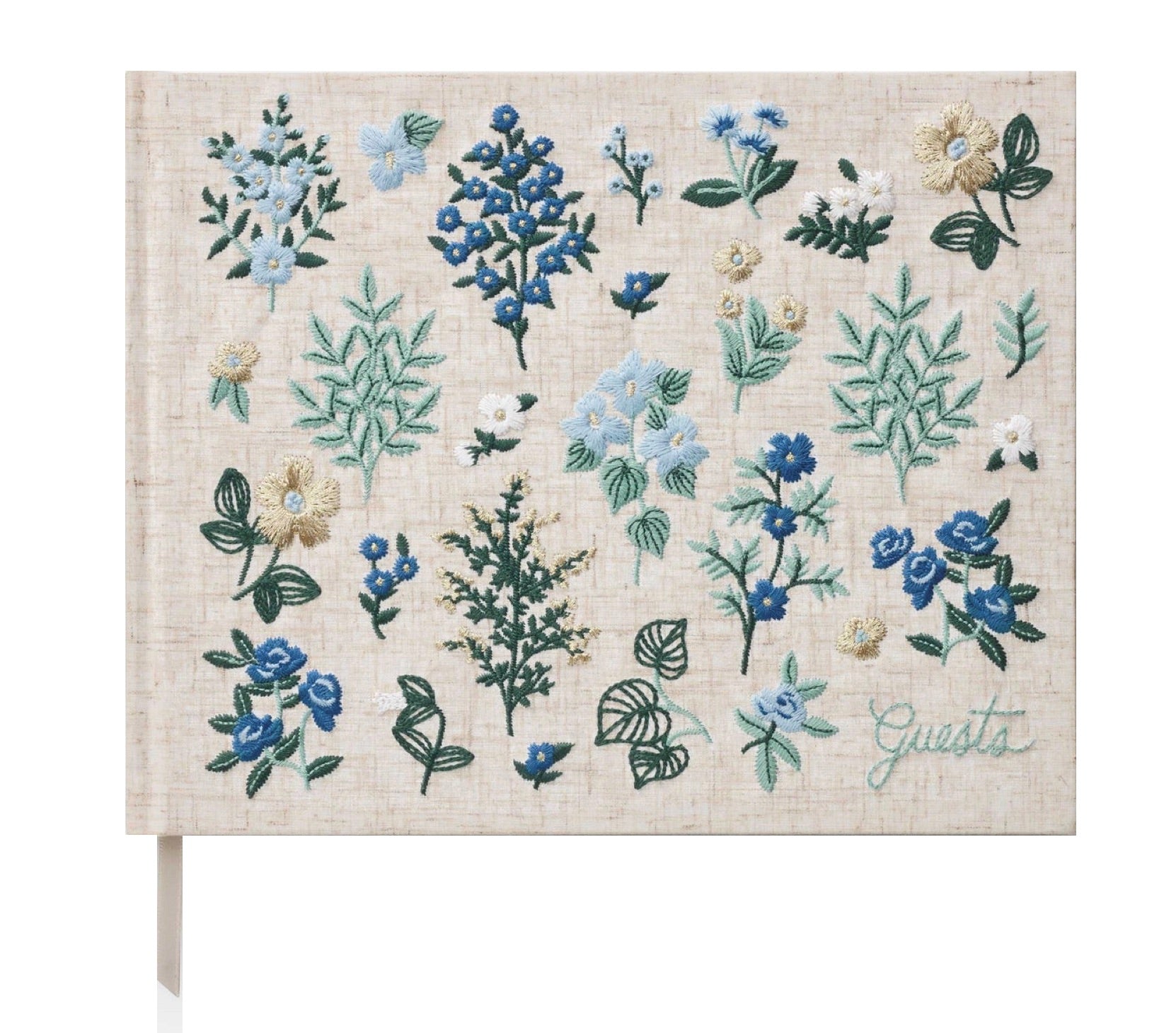 The Wildwood Embroidered Guest Book by Riffle Paper Co. features beige fabric, blue, white, and green floral embroidery, and "Guests" stitched in the corner—an elegant keepsake for special events.