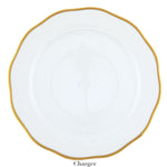 The Gwendolyn White and Gold Collection charger plate by Herend features a wavy rim, elegant white porcelain, and a 24k gold border—an ideal choice for those with refined artistic taste.