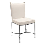 The Amalfi Dining Side Chair in Slate by Janus et Cie features a black metal frame with a white cushioned seat and backrest, showcasing minimalist design and outdoor elegance.