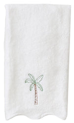 The Palm Tree Scalloped Hand Towel by Weezie Towels features elegant palm tree embroidery near the bottom center, adding a tropical touch to your space.