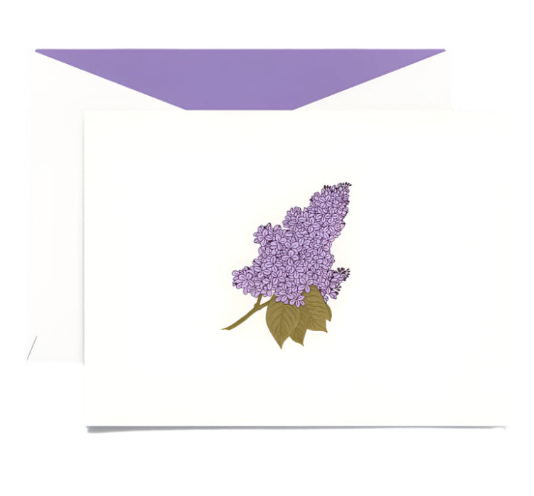 The Lilac Classic Card Set by Crane features a white engraved card with a purple lilac flower illustration, inspired by blooming bushes, and comes with a white envelope lined in lavender.