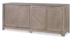 The Bernard Buffet by Highland House is a wooden sideboard with four paneled doors, adjustable shelves, a light grey-brown finish, and short legs.