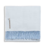 Alicia Adams Alpaca Classic Herringbone Throw, light blue with soft fringe and fabric label, fair-trade made in Peru, displayed folded on a white background.