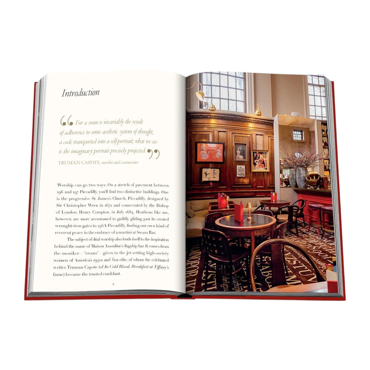 An open book displays text on the left page and a photo on the right of Swans Bar by Assouline, featuring a cozy, art-filled dining space with round tables, chairs, Assouline books, and elegant cocktails.