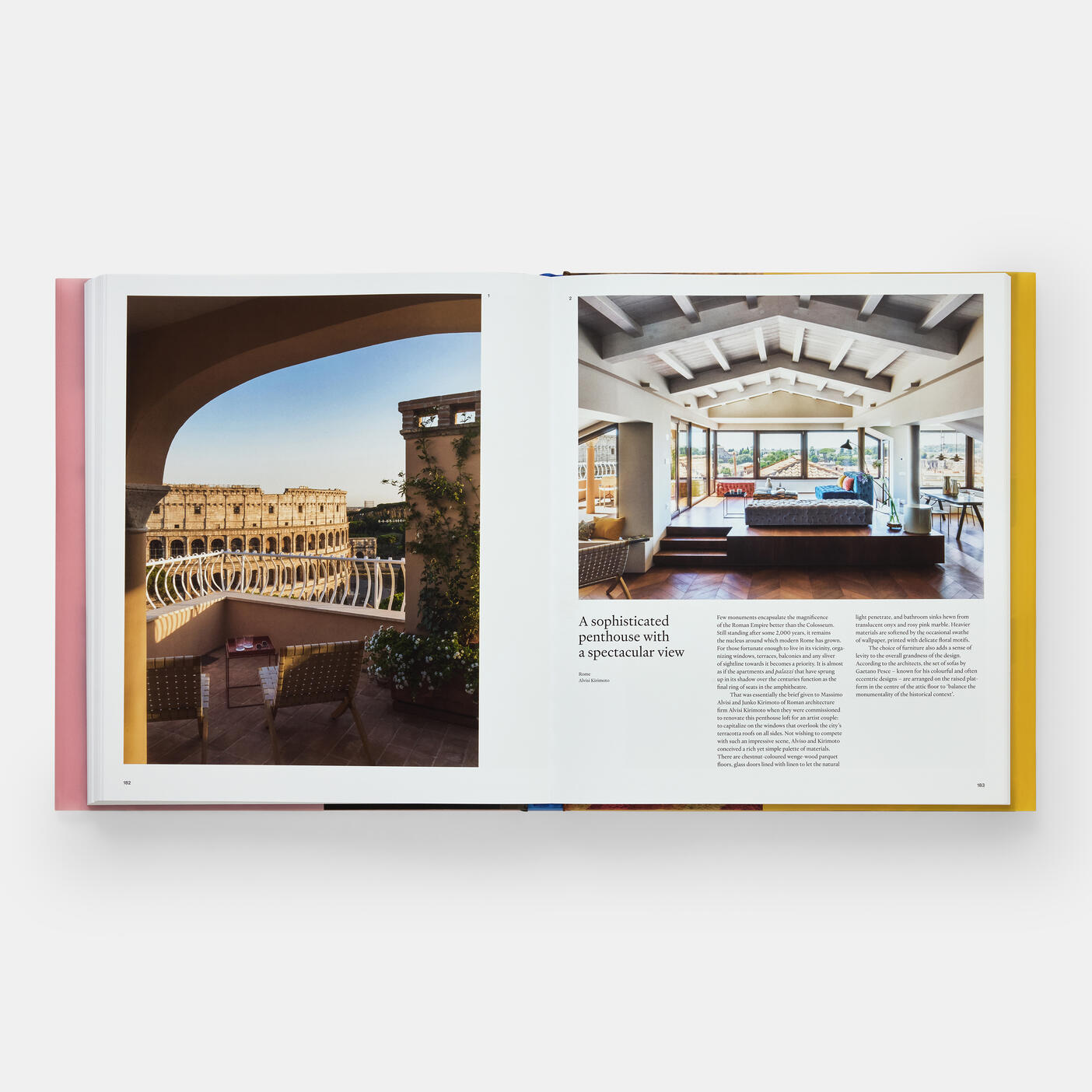 The opened pages of "Italian Interiors: Rooms with a View" by Phaidon reveal a breathtaking penthouse balcony view beside a roomy living area characterized by wooden beams and expansive windows, epitomizing the sophistication often associated with Italian interior design.