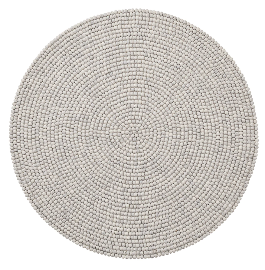 The Kim Seybert Driftwood Gray Placemat features handcrafted, small felt balls in concentric circles, offering a stylish round design that’s perfect for outdoor entertaining.