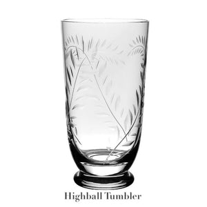 Handmade clear glass highball tumbler from the William Yeoward Crystal Jasmine Drinkware Collection, featuring a hand-engraved leaf pattern and solid, raised base. Displayed on white background, ideal for any occasion.