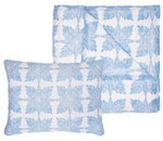 The Jaya Azure Bedding Collection by John Robshaw features white cotton voile pillowcases and quilts with a blue, symmetrical floral block print. Hand-crafted details add artisanal charm. Final Sale.