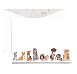 The Dog Group Folded Card Set by Crane features eight cheerful dogs illustrated along the bottom of a pearl white notecard, paired with a matching envelope.