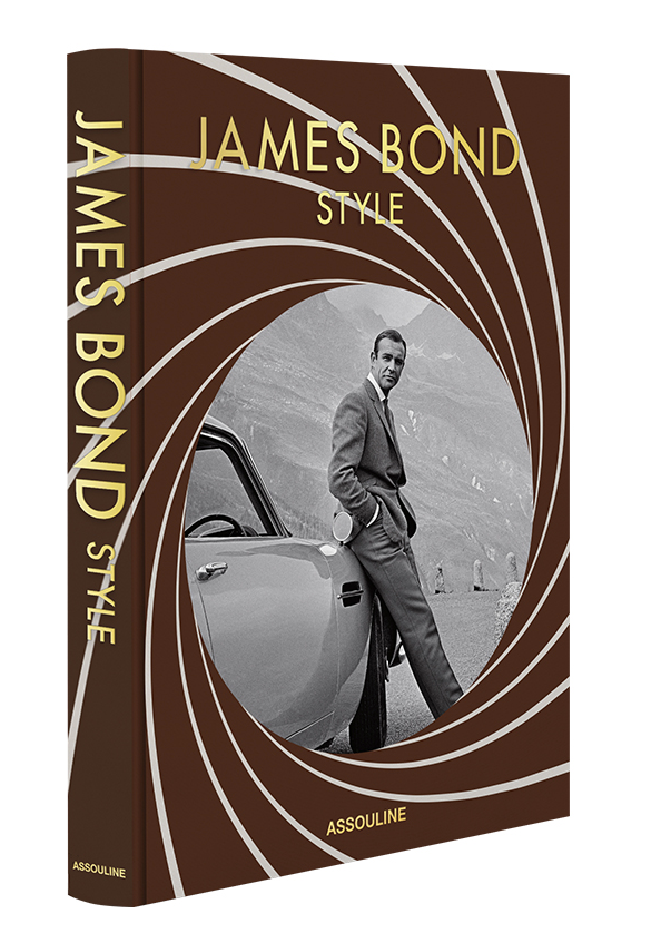 The cover of Assouline's "James Bond Style" perfectly captures classic fashion, featuring a man in a suit leaning against a car, all set against a stylish barrel design on a brown background.
