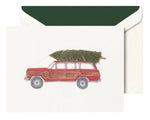 The Crane Jeep with Tree Card Set features a vintage Jeep carrying a Christmas tree on the front, evoking holiday spirit. Each greeting card includes a green-lined envelope, perfect for festive messages.