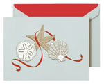 The Crane Elegant Christmas Seashells Card Set features a seaside card with sand dollar, starfish, and scallop shell designs accented by a red ribbon, plus a matching envelope with red lining—ideal for adding coastal charm to your holiday greetings.