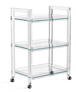 The Interlude Home Ava Bar Cart offers a modern look with its three-tiered acrylic and glass design, clear shelves, and four black caster wheels.