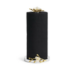 The Orchid Paper Towel Holder by Michael Aram features a black paper towel roll standing vertically on a silver holder, accented with gold and white floral designs at the base and top, capturing the elegance of the Orchid Collection.