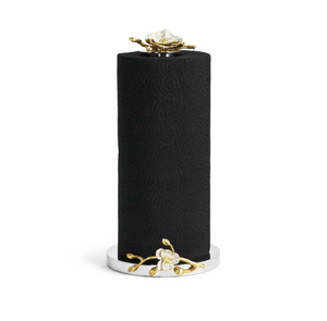 The Orchid Paper Towel Holder by Michael Aram features a black paper towel roll standing vertically on a silver holder, accented with gold and white floral designs at the base and top, capturing the elegance of the Orchid Collection.