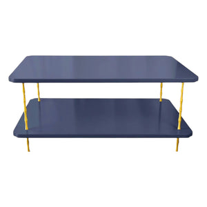 The Satin Lacquered Coffee Table by Two Worlds Arts Group features a rectangular two-tier design in navy blue with brass bamboo legs, shown from the front against a white background.