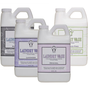 Four one-gallon bottles of Le Blanc Laundry Wash are displayed, each featuring a distinct scent—Powder, Lavender, Original, and Scent-Free—showcasing a versatile fragrance selection ideal for cold water use.