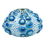 The Herend Reserve Collection Large Sea Urchin is a blue and white ceramic piece with a rounded shape, featuring raised circular blue patterns reminiscent of the brand's iconic fishnet design.