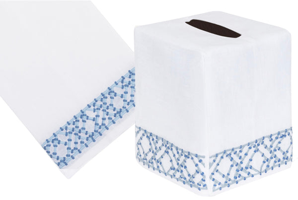 A white tissue box cover with a Lido Collection, Blue mosaic design and a matching white Italian linen tissue with a hand-embroidered blue border by Haute Home.