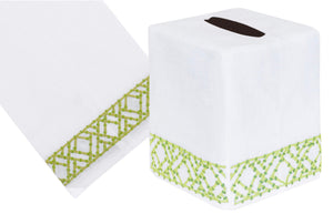 The Lido Bath Collection in green by Haute Home offers a white tissue box cover and matching towel, crafted from exquisite Italian linen with a green hand-embroidered geometric border design.