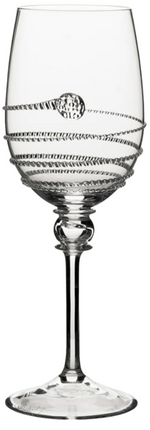 A clear wine glass from the Juliska Amalia Drinkware Collection, featuring a decorative spiral along the bowl and a signature round accent on one side.