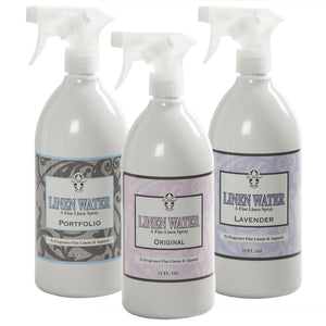 Three 32 fl oz bottles of Le Blanc Linen Water Spray—Portfolio, Original, and Lavender scents—are arranged side by side, perfect for refreshing your household linens.