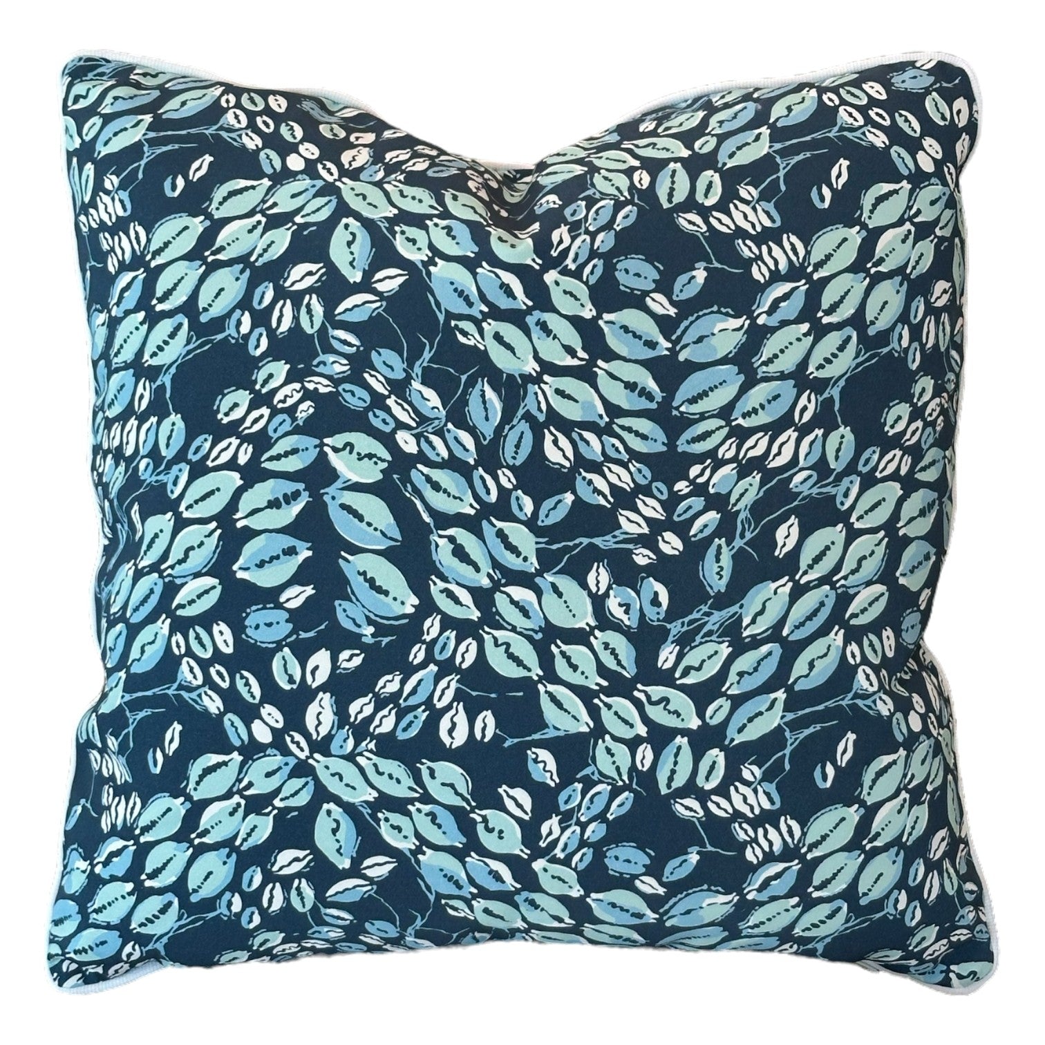 The Associated Design Cowrie Shell Navy Outdoor Pillow features a blue and green leaf pattern on a dark background, crafted from premium materials and shown against a white backdrop.