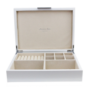 The Addison Ross Lacquer Jewelry Box features a polished open white finish, multiple compartments including a ring section, and a beige suede lining with “Addison Ross London” printed inside the lid.