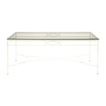The Amalfi Cocktail Table in White Vermouth by Janus et Cie features a rectangular glass top, white metal frame, and decorative crossbar—perfect for stylish outdoor spaces.