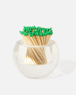 The Acrylic Match Striker Collection by Tart by Taylor features green-tipped matches in a clear container, creating a chic coffee table accent displayed on a plain white background.