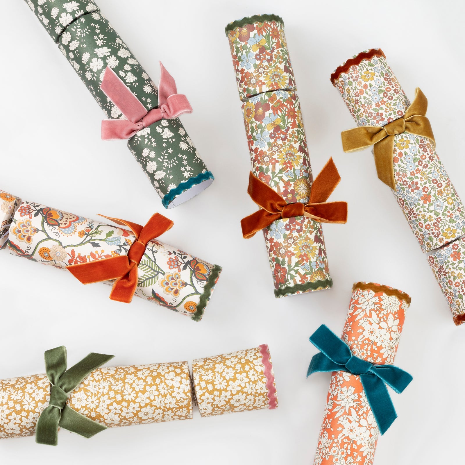 The Meri Meri Liberty Fall Velvet Bows Crackers feature six luxury party crackers with floral patterns and colorful velvet bows—ideal for adding charm to your fall dinner table decor.