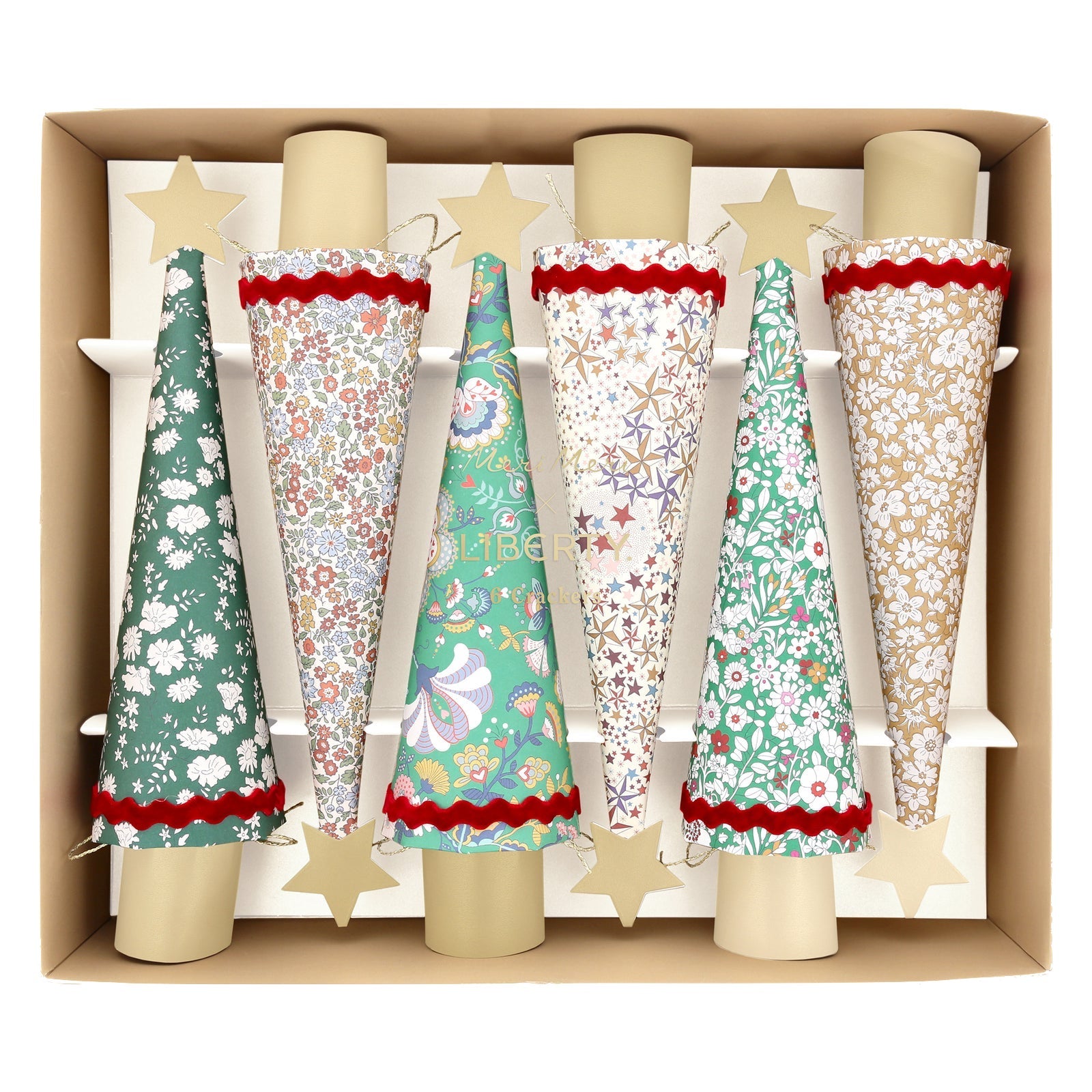 Meri Meri’s Liberty Tree Crackers feature five tree-shaped party crackers with Liberty floral prints and gold star toppers, beautifully arranged upright in a box—perfect for festive Christmas dinner decorations.