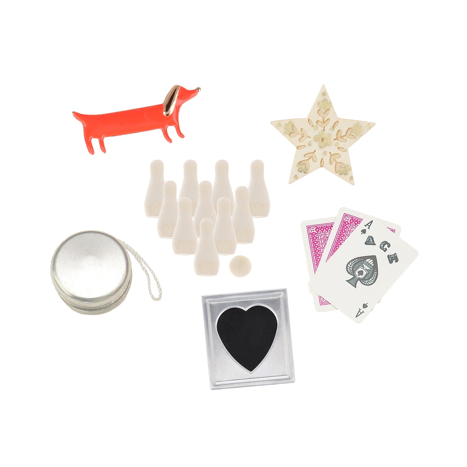 A selection of mini game pieces, cards, a yo-yo, star ornament, tin, and red dog figurine displayed with Meri Meri Liberty Tree Crackers on a white background.