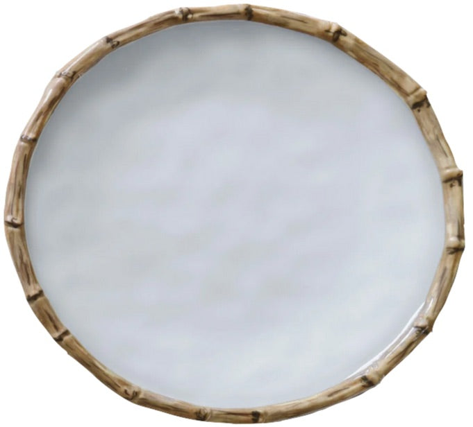 This round white plate from the Beatriz Ball Vida Natural Bamboo Dinnerware Collection features a bamboo-style rim, blending luxury style with break-resistant melamine.