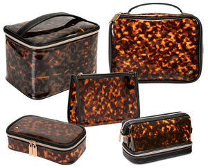 The Miami Tortoise Travel Collection by Stephanie Johnson features five tortoiseshell-patterned cosmetic bags with faux-leather trim in assorted shapes and sizes—perfect for stylishly organizing your essentials.