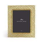 The Love Knot Gold Frame Collection by Michael Aram features a rectangular frame with an intricate gold lattice design, beautifully symbolizing unity, and includes a placeholder marked "Michael Aram" with the size 8x10.