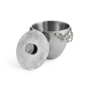 The Michael Aram Ocean Reef Ice Bucket features a stainless steel body with an open lid and coral branch-inspired handles, displayed against a white background.