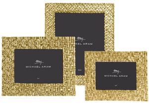 Three Michael Aram Palm Gold Frame Collection picture frames showcase sculpted antique gold textures, arranged overlapping, each with a black placeholder displaying the designer’s logo.
