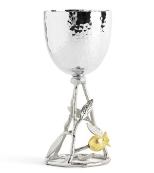 The Michael Aram Pomegranate Silver & Gold Kiddish Cup features a hammered silver goblet atop a branch-inspired base with leaves and a gold pomegranate.