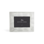 The Michael Aram Reflective Frame Nickel Collection is a square, silver-toned picture frame with a simple brushed finish and a brand-name placeholder insert.