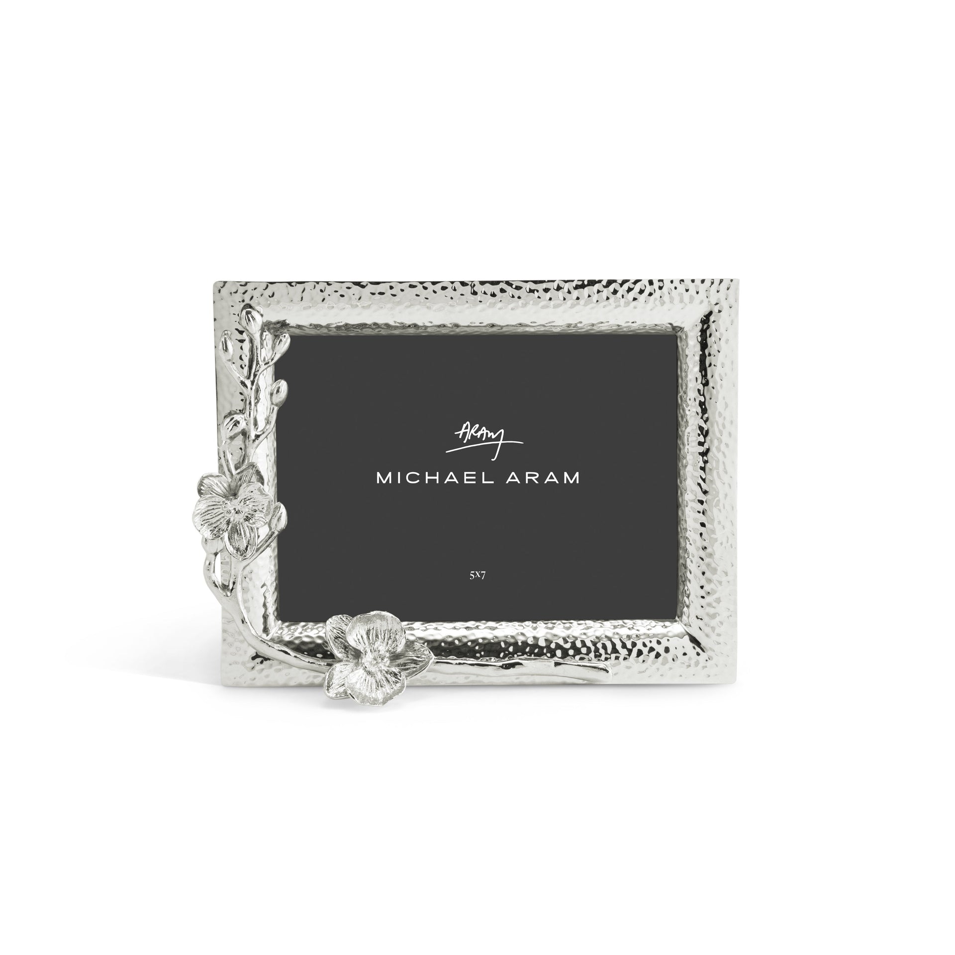 Silver rectangular photo frame from Michael Aram’s White Orchid Frame Collection, featuring a hammered texture and orchid-inspired floral accents on the lower left corner, with “Michael Aram” placeholder displayed.