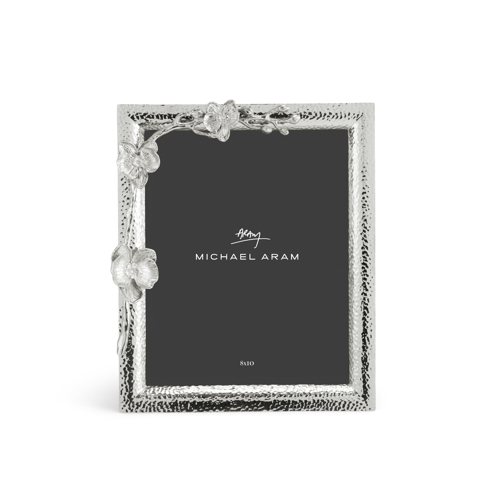 The Michael Aram White Orchid Frame Collection features textured silver edges with decorative leaves and butterfly, showcasing a card labeled "Michael Aram" on a black background that captures the elegance of an orchid in bloom.