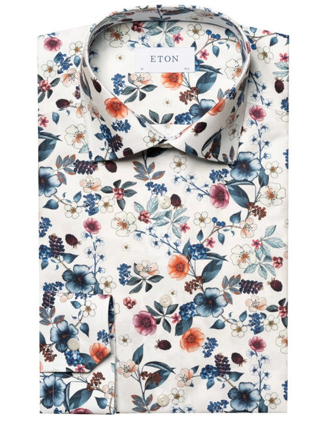 A folded Eton White Floral Print Signature Twill Shirt with long sleeves and a spread collar, featuring vibrant flowers and leaves on a white background.