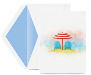 The Crane Perfect Day Ocean Note Card Set by Crane features two blue beach chairs and a red-striped umbrella on a sandy beach, paired with a matching blue and white envelope.