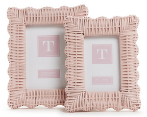 The Wicker Weave Scalloped Frame Collection in pink by Two's Company features two woven rattan frames with scalloped edges, each showcasing a placeholder image and highlighting skilled craftsmanship and rustic charm.