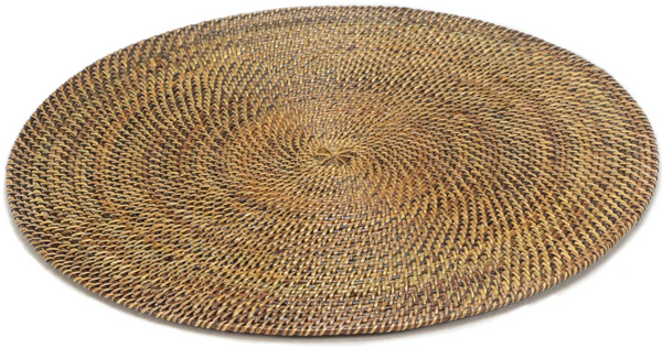 Handmade Calaisio round woven placemat with concentric circular patterns.