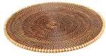 The Calaisio Round Placemat is handcrafted from natural vines with a delicate beaded edge, shown on a white background.