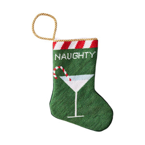 The Naughty Needle Point Stocking by Bauble Stockings features green hand-stitched needlepoint, red and white trim, "NAUGHTY" text, and a martini glass with a candy cane—perfect as a festive or playful holiday gift.