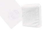 The Nautilus Shell Bath Collection in white by Haute Home exudes elegance with its embossed spiral shell design. One towel is folded and the other lies flat, highlighting their beauty on Italian linen.